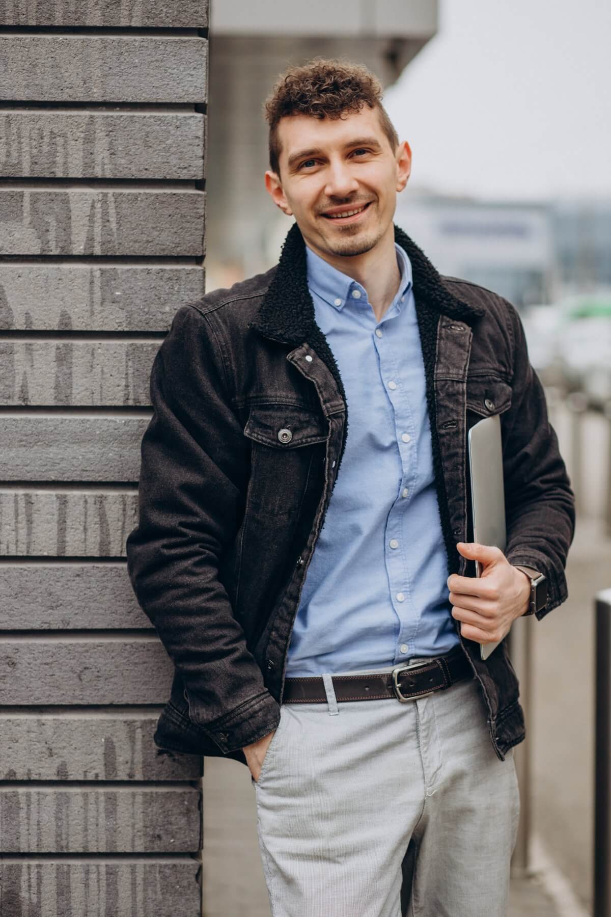 handsome-man-standing-street-holding-laptop